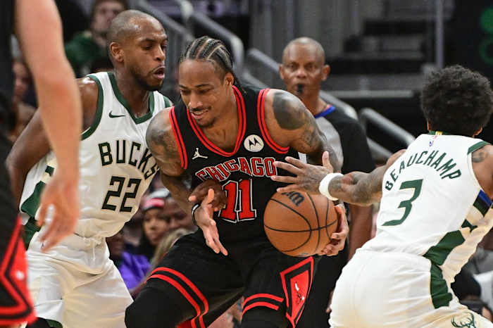Chicago Bulls guard DeMar DeRozan (11) gets pressure from Milwaukee Bucks center Khris Middleton (22) and guard MarJon Beauchamp (3) in the fourth quarter at Fiserv Forum.